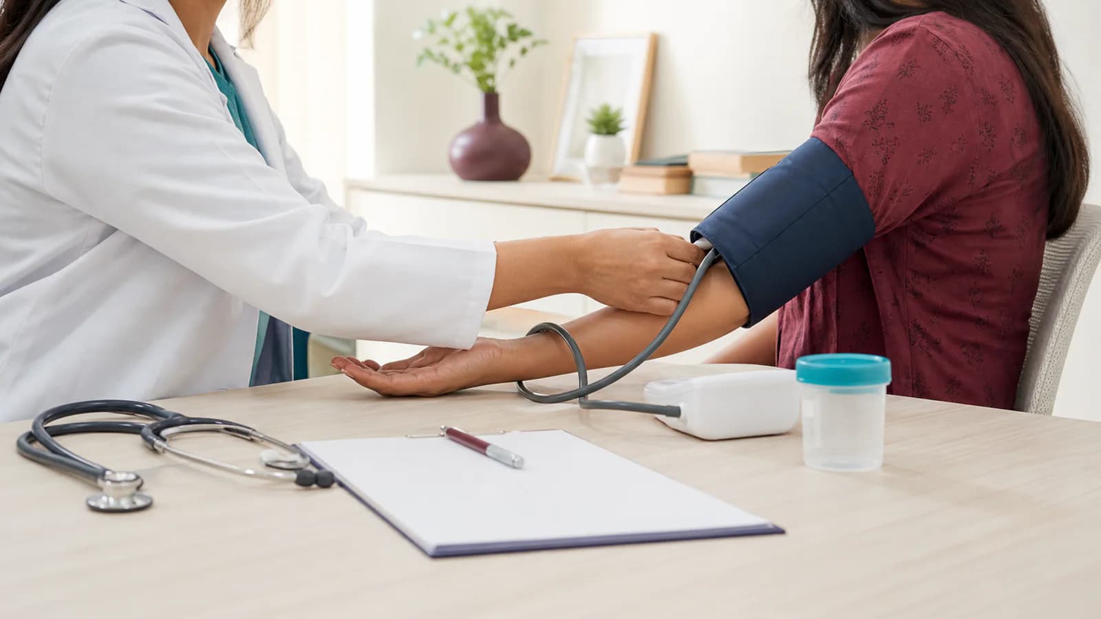 Illustrative women’s preventive health check with a blood pressure measurement