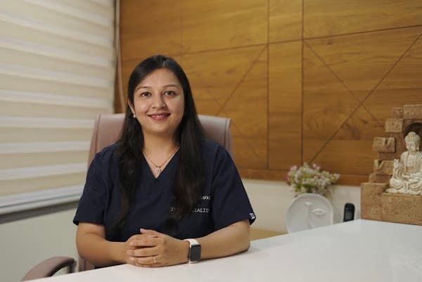 Dr. Grishma Thakkar seated in her clinic